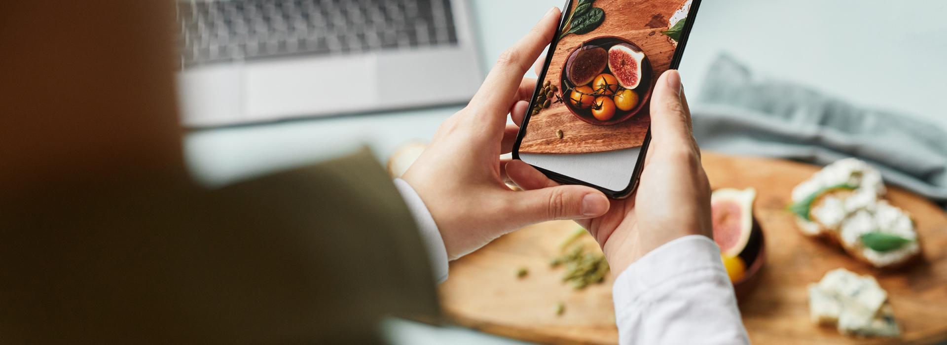 Person photographing food with a smartphone
